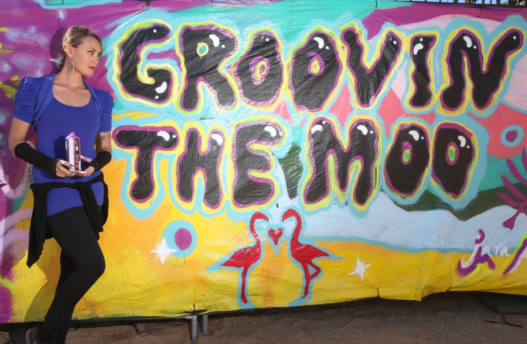 PAINT: Jara Gillick-Lewis with part of the mural Hiphopportunities created. Picture GLENN DANIELS