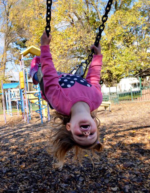 FUN: Zoe Osicka plays on the swings at the Heathcote playground. Picture: BRENDAN McCARTHY