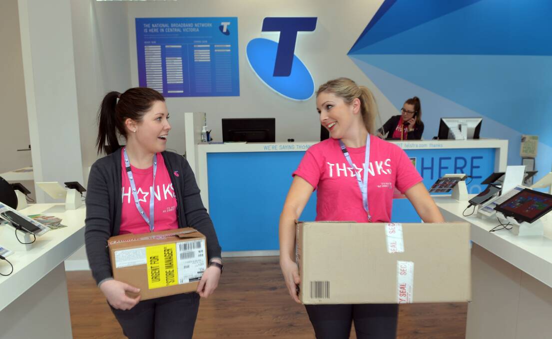 RUSH: Telstra Mitchell Street manager Chloe Carolan and Hannah Kenyon prepare for the iPhone6 launch.