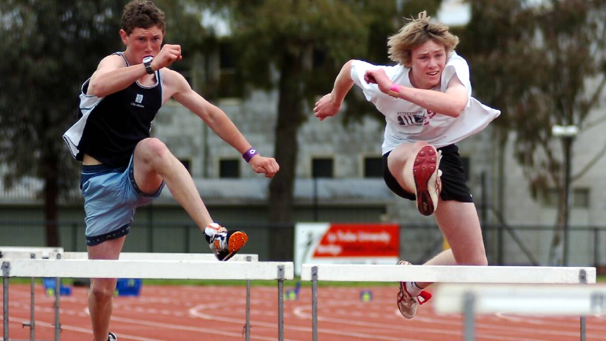 Sam Hewitt and Nathan Coad (right) in the 100m hurdles.
pic by Andrew Perryman on Sat 29th Oct 2005.