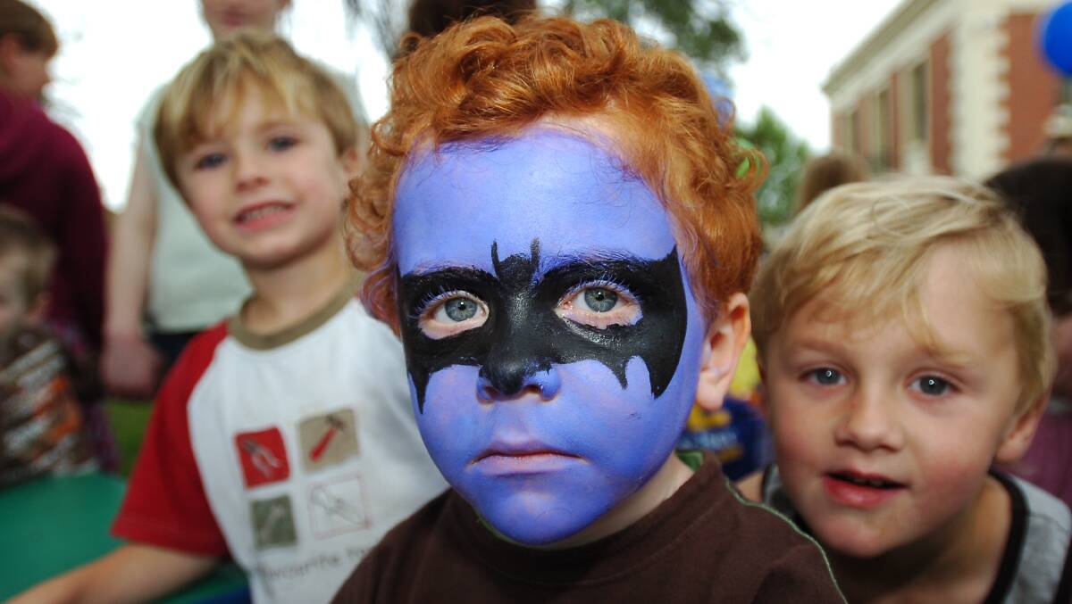 Tom Rodda (batman) with Joel and Caleb Green enjoing the face painting at the kids character carnival
pic by Bill Conroy 29/10/05