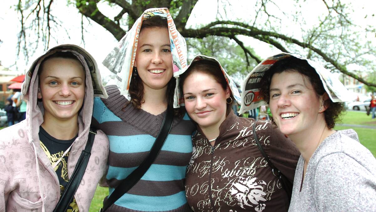 Kaitlin Wright, Teagan Conley, Sarah Eames and Sally Hicks trying to keep dry at the kids character carnival
pic by Bill Conroy 29/10/05