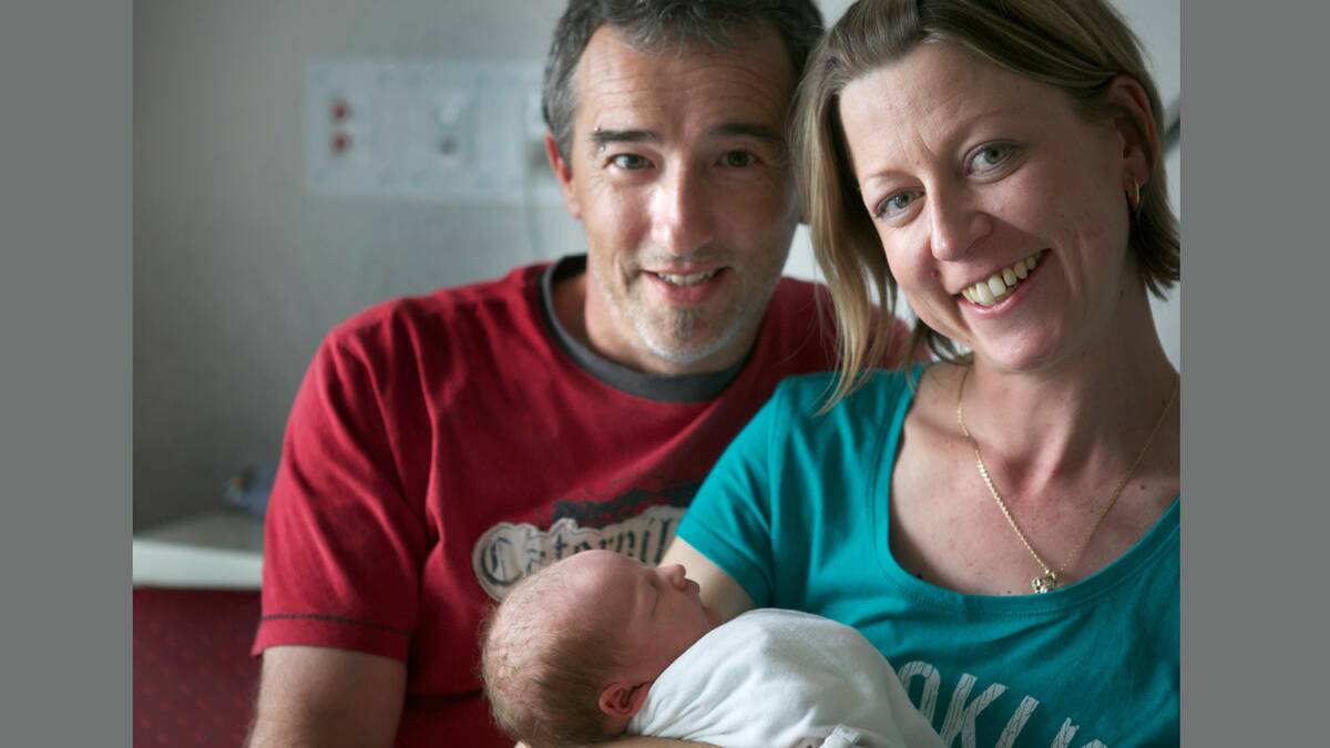 HAPPY: Parents Michael Cauchi and Peta Boyle with new son Max. Picture: EDDIE JIM