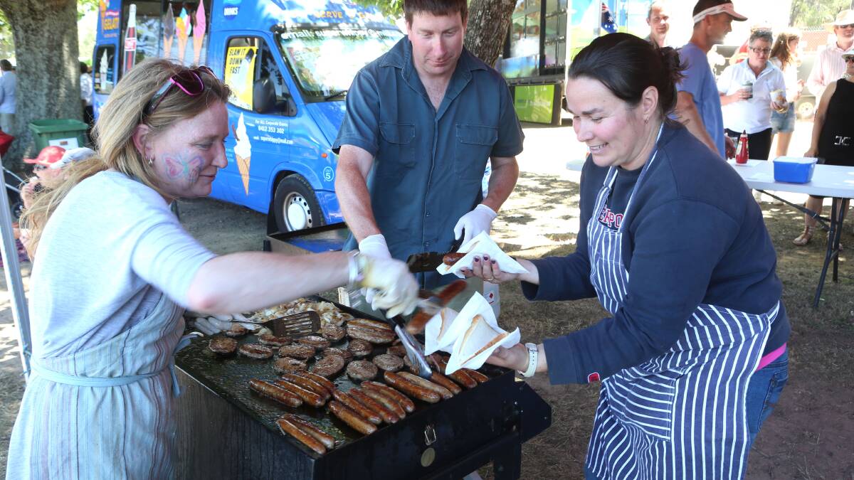 Working the BBQ for Romsey Primary School are Sam King, Mark Perkins and Kerry Hammond. Picture: PETER WEAVING