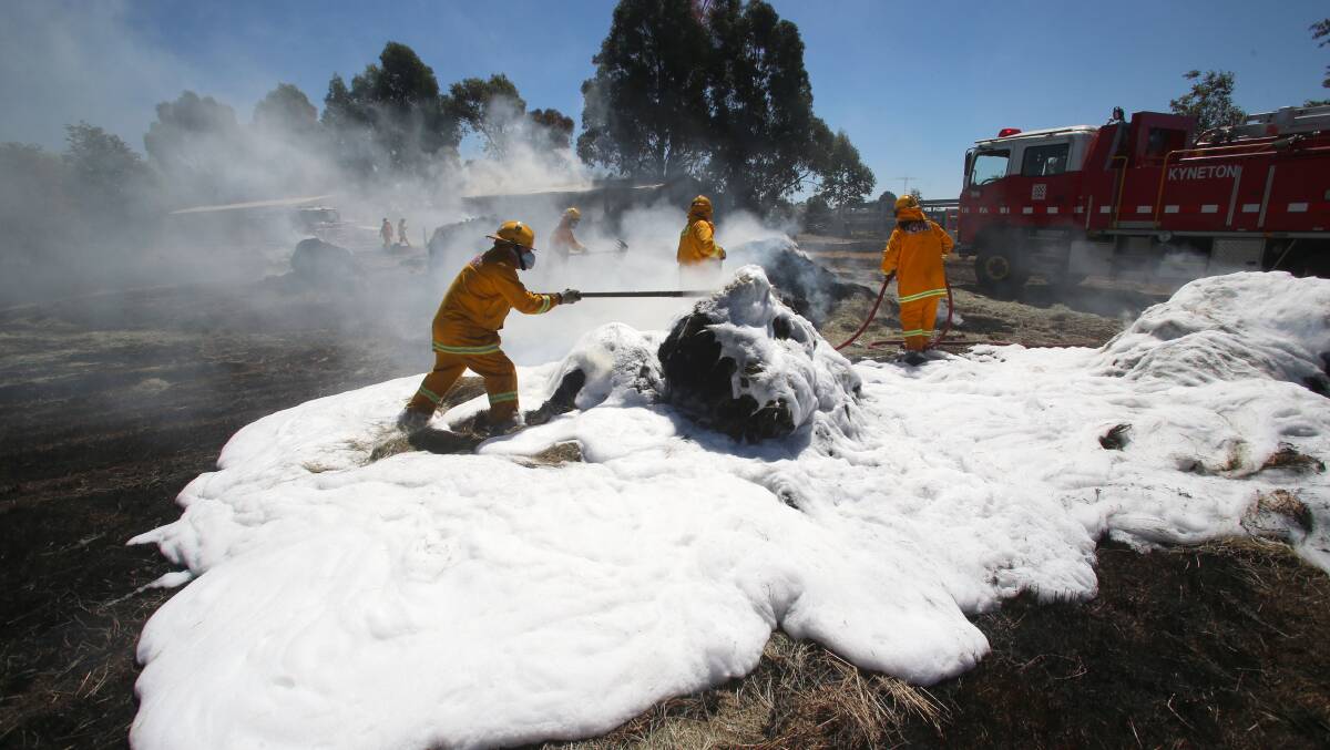 CFA using foam to put out fire in hay at Greenhills fire near Kyneton.
Picture: PETER WEAVING