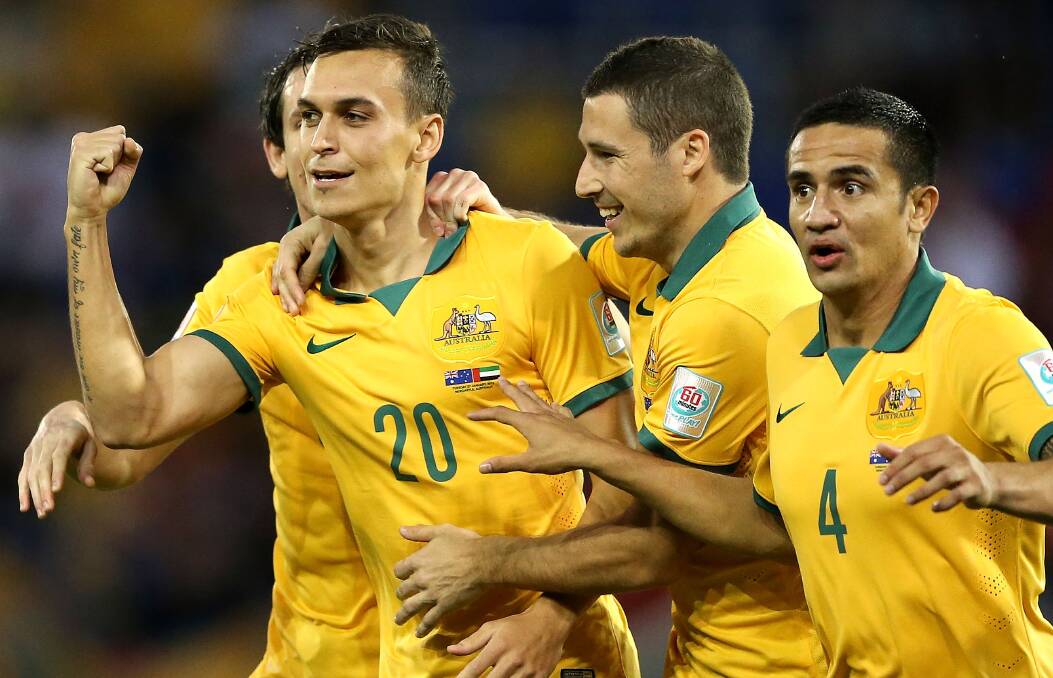 JUBILANT: Socceroos teammates celebrate a goal during last night's win against UAE. Picture: GETTY IMAGES