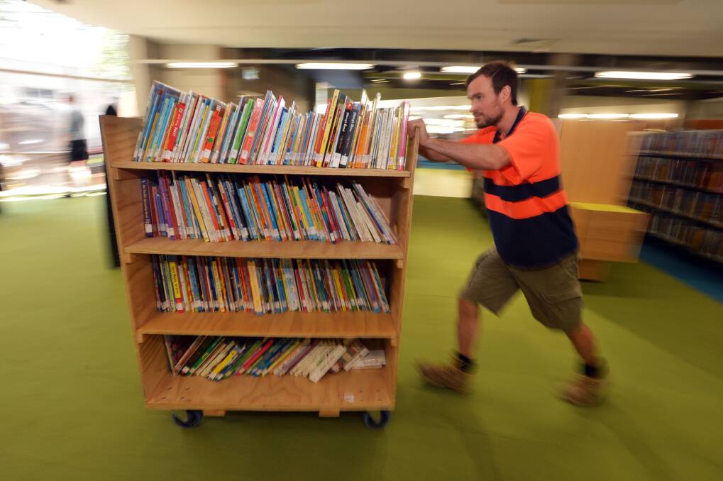 Rob Linnert of ABR RElocations moving a book trolley. Picture: BRENDAN McCARTHY