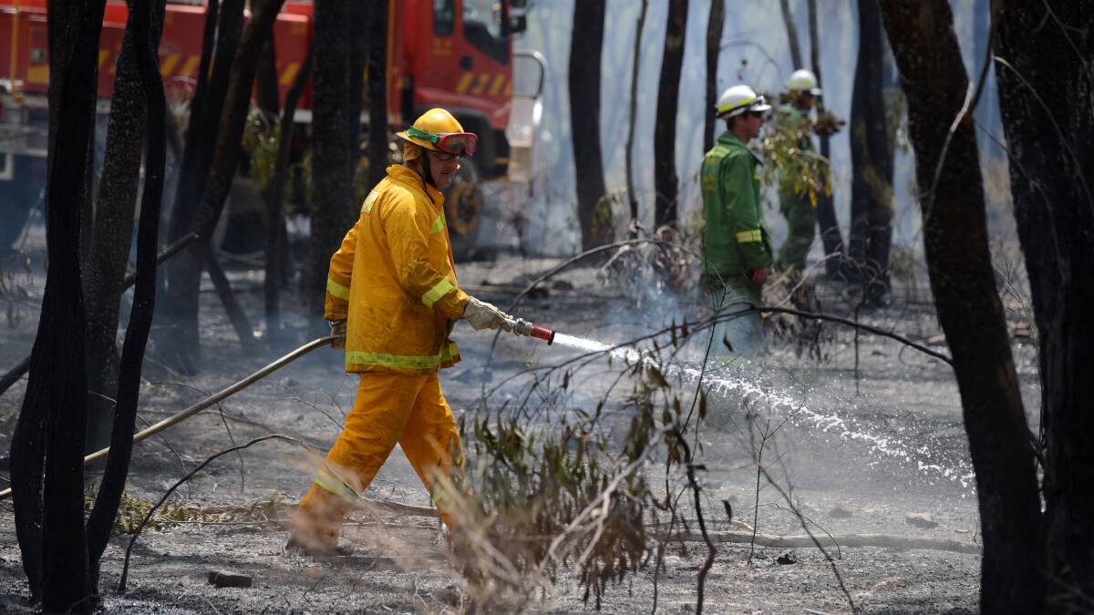 CONTROL: The CFA and DEPI mop up a blaze started by lightning near Axe Creek. Picture: JIM ALDERSEY