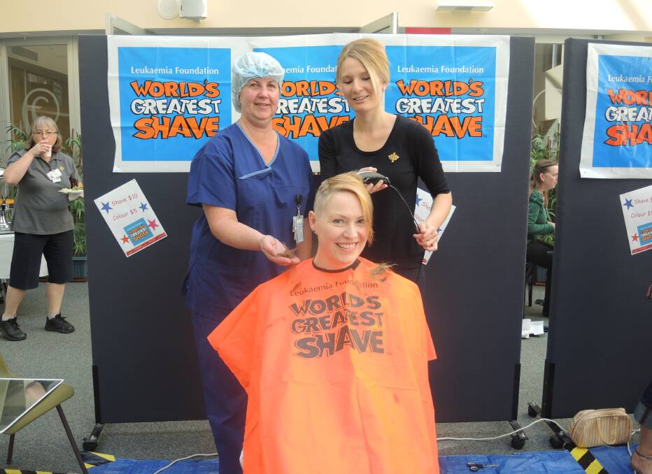 St John of God Hospital  theatre manage Denise Leech shaves Naomi Fayers' head, after paying $75 for the privilege