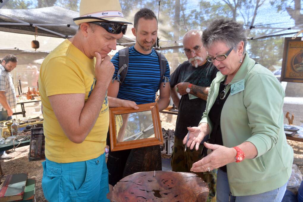 Prof Jeffrey Stillwell, Sean Jago, Rocky Huxley and June Huxley negotiating a price at the Fryerstown Antique fair. Picture: BRENDAN McCARTHY