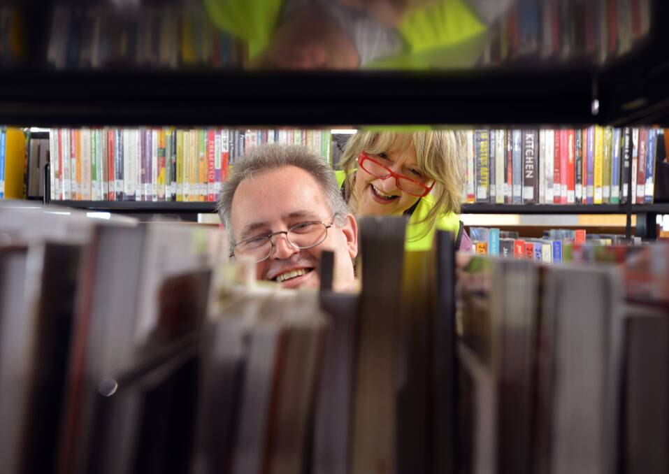 Staff members Andrew Stubs and Andrea Meersbergen are stacking the shelves. Picture: BRENDAN McCARTHY