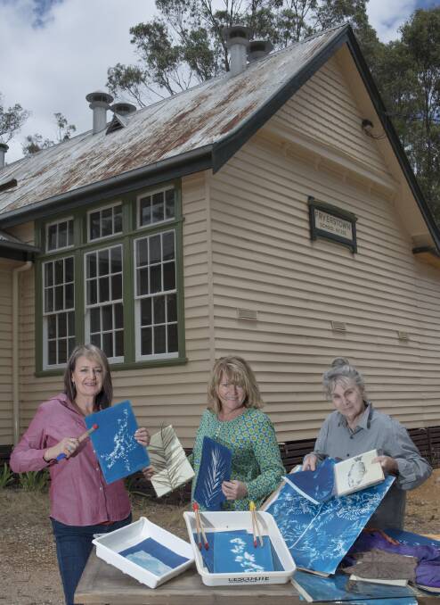 Julie Hough, Marion Williams and Julie Millowick with examples of cyanotype artworks. Picture: CHRISTINE SAYER