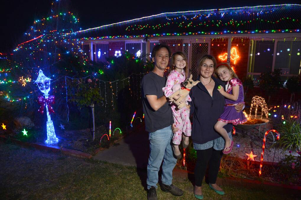 RADIANT: Joel Stratford, Vasey McKindley, Tiffany Peters and Zoe Peters look at Christmas lights on a house in Excell Street.