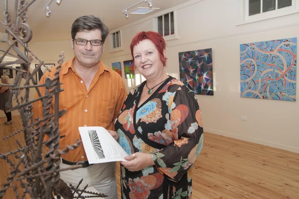 SHOWCASE: Dr Chris McAuliffe and Denise Button at the exhibition.  Picture: JULIE MILLOWICK