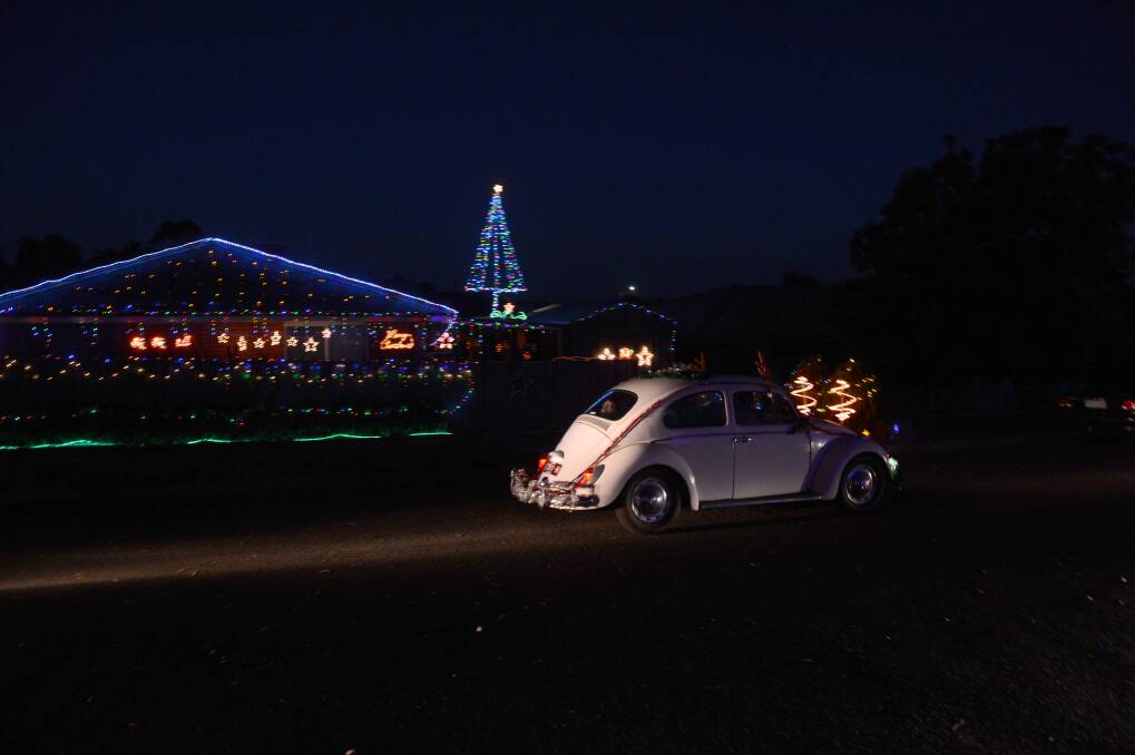 A VW Beetle cruises past the Christmas Lights in Britain st. Picture: JIM ALDERSEY