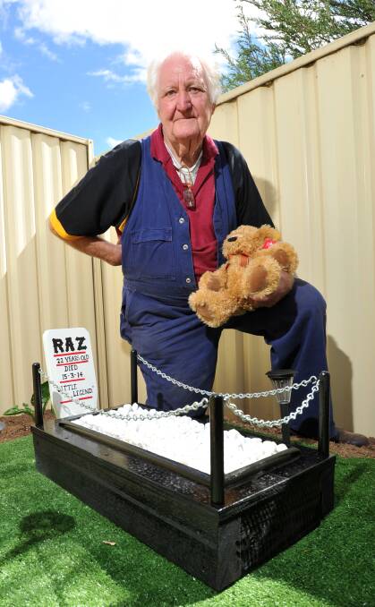 TRIBUTE: Ian Warhurst with the bear next to Raz's final resting place. Picture: JODIE DONNELLAN