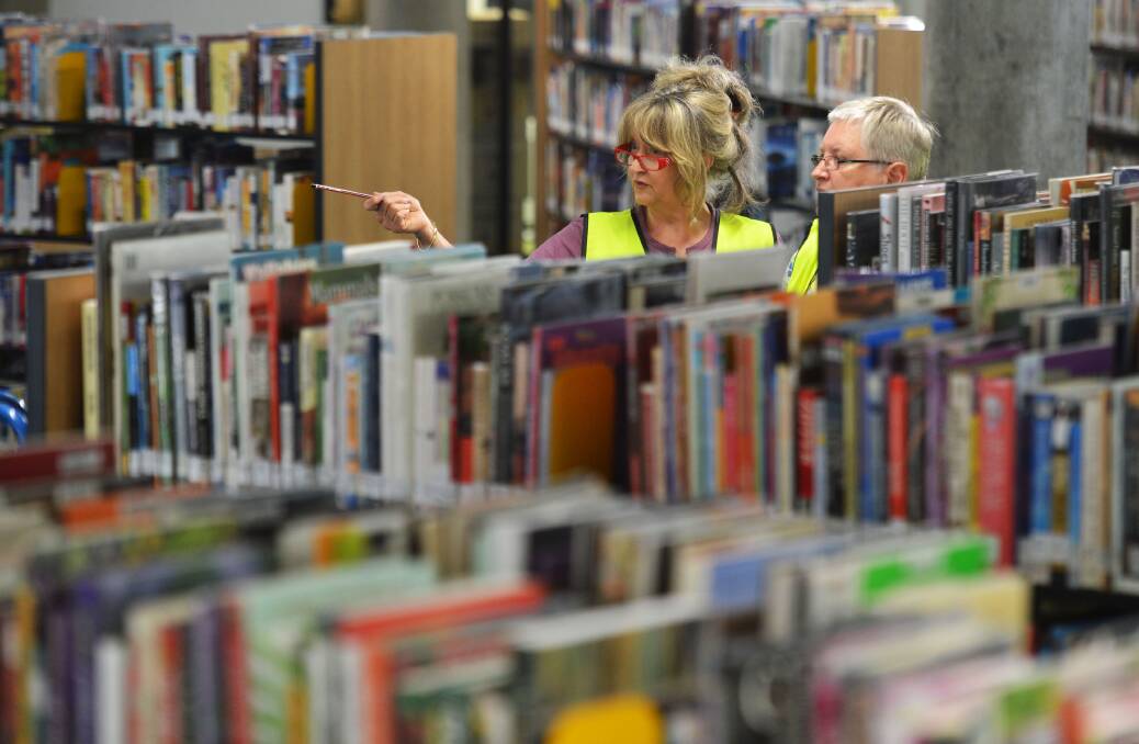 Staff member Andrea Meersbergen and Library Manager Vivien Newton are stacking the shelves. Picture: BRENDAN McCARTHY