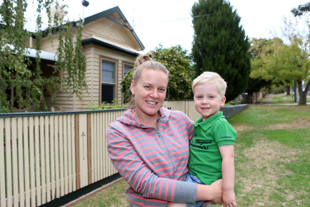 FAMILY HOME: Chelsea and Max Haw outside their home on Malcolm Street. Picture: GLENN DANIELS