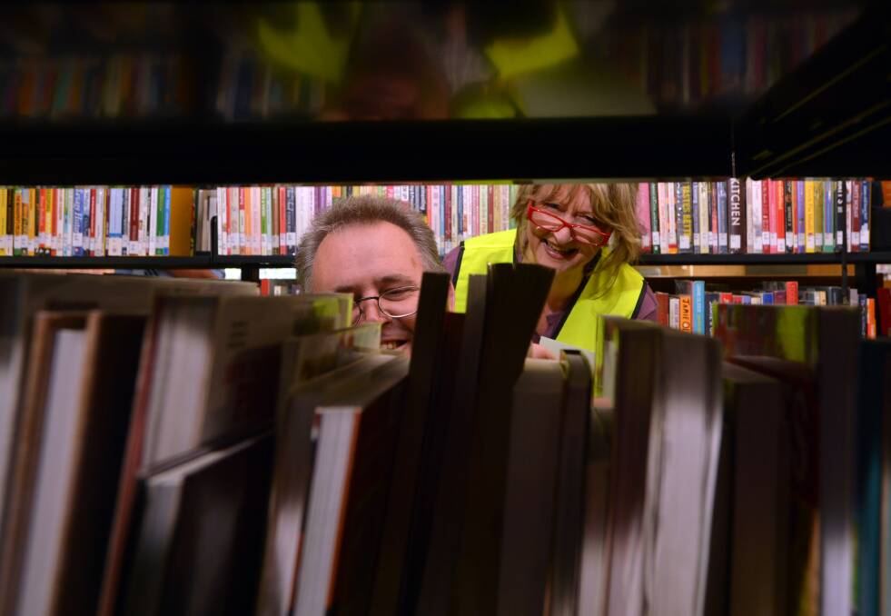 Staff members Andrew Stubs and Andrea Meersbergen are stacking the shelves. Picture: BRENDAN McCARTHY