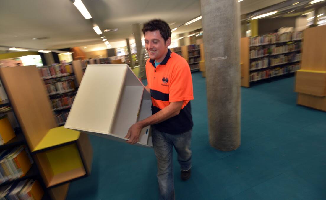 Eamonn David of ABR Relocations moving a book shelf. Picture: BRENDAN McCARTHY