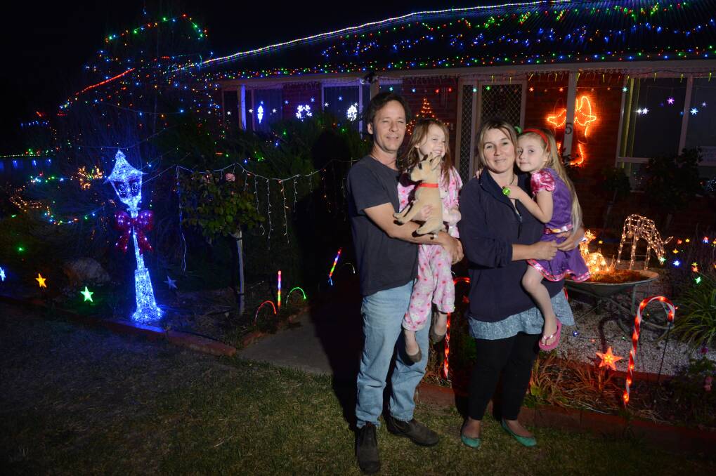 Joel Stratford, Vasey McKindley, Tiffany Peters and Zoe Peters look at Christmas lights on a house in Excell st. Picture: JIM ALDERSEY