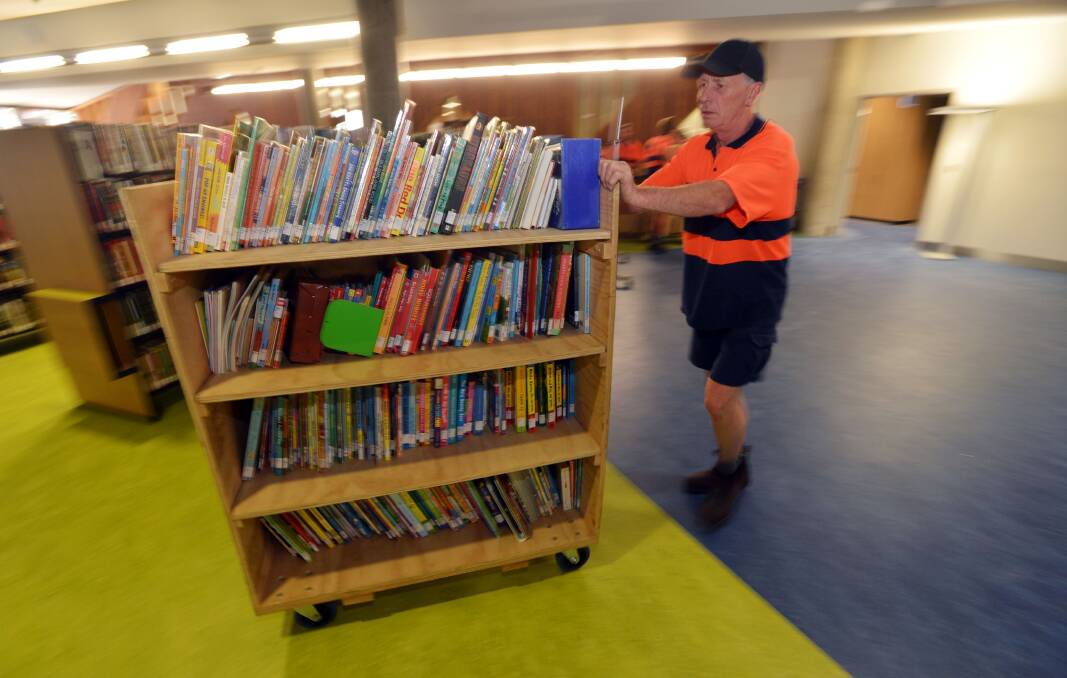 Graeme Gordon of of ABR Relocations moving a book trolley. Picture: BRENDAN McCARTHY
