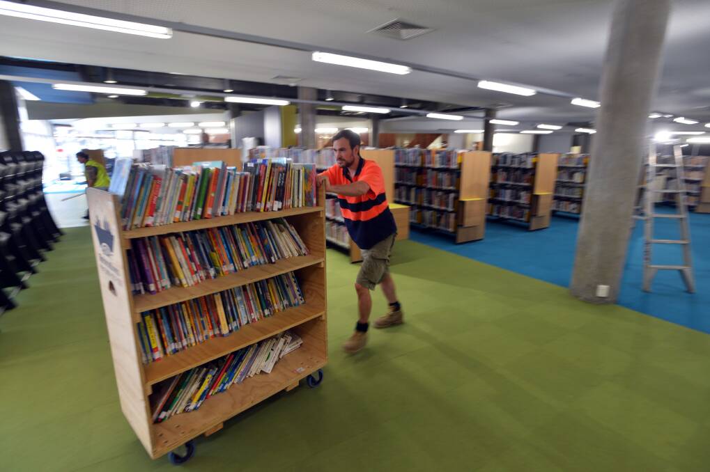 Rob Linnert of ABR RElocations moving a book trolley. Picture: BRENDAN McCARTHY