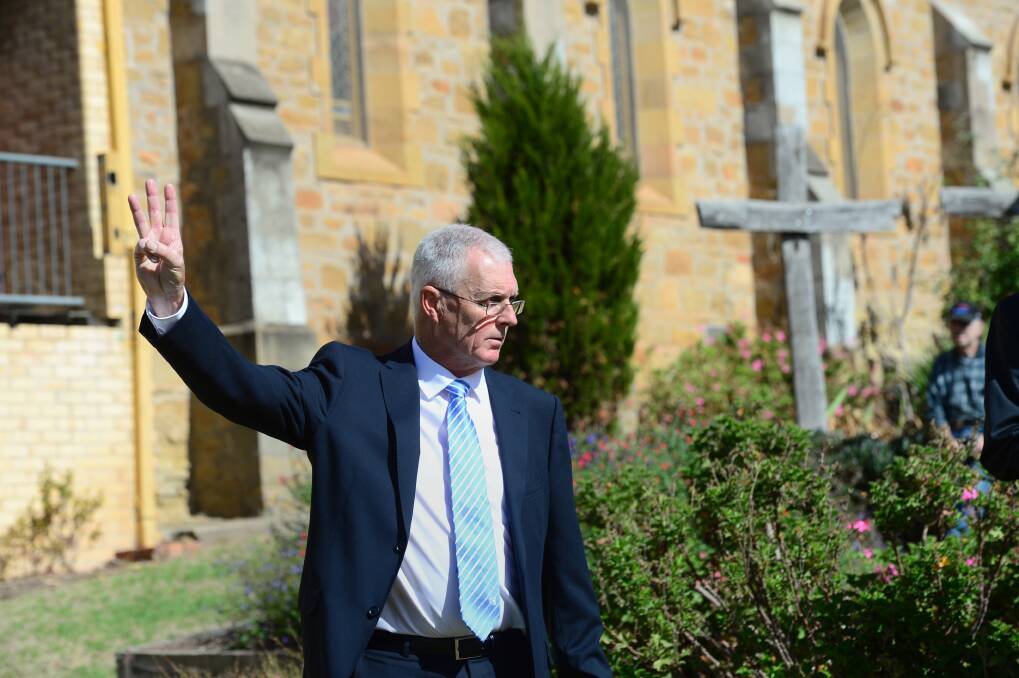 PASSED IN: Craig Tweed conducts the auction of the All Saints Cathedral. Picture: JIM ALDERSEY