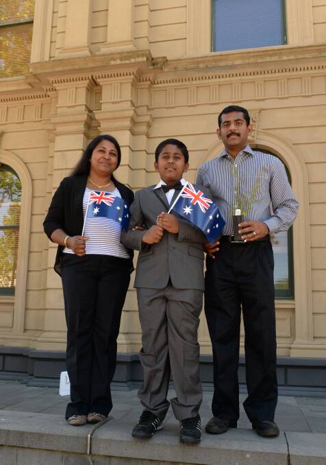 NEW OPPORTUNITY: Australian citizens Sini Thomas and Alfred Ajith with Jose Aji. Picture: LIZ FLEMING