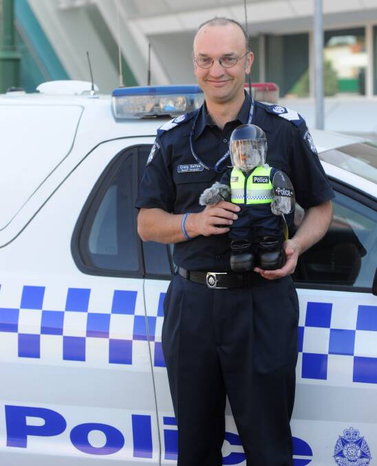 14TH EDITION: Senior Sergeant Craig Gaffee welcomes Constable T. Bear to the Bendigo Police Station. The bear goes on sale today.