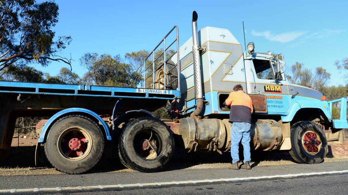 CRASH: John Hatchell-Brown inspects his truck after the crash. Picture: JIM ALDERSEY