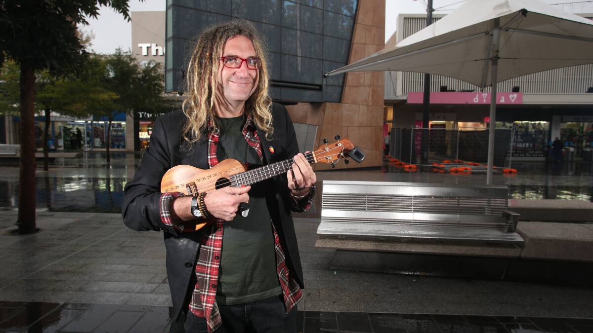 Busker Dave performing at his regular spot outside Officeworks.