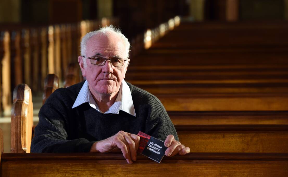 DISAPPOINTED: Sacred Heart Cathedral's Monsignor Frank Marriott holds the booklet that was left on his and other parishoners' cars. Picture: JODIE DONNELLAN