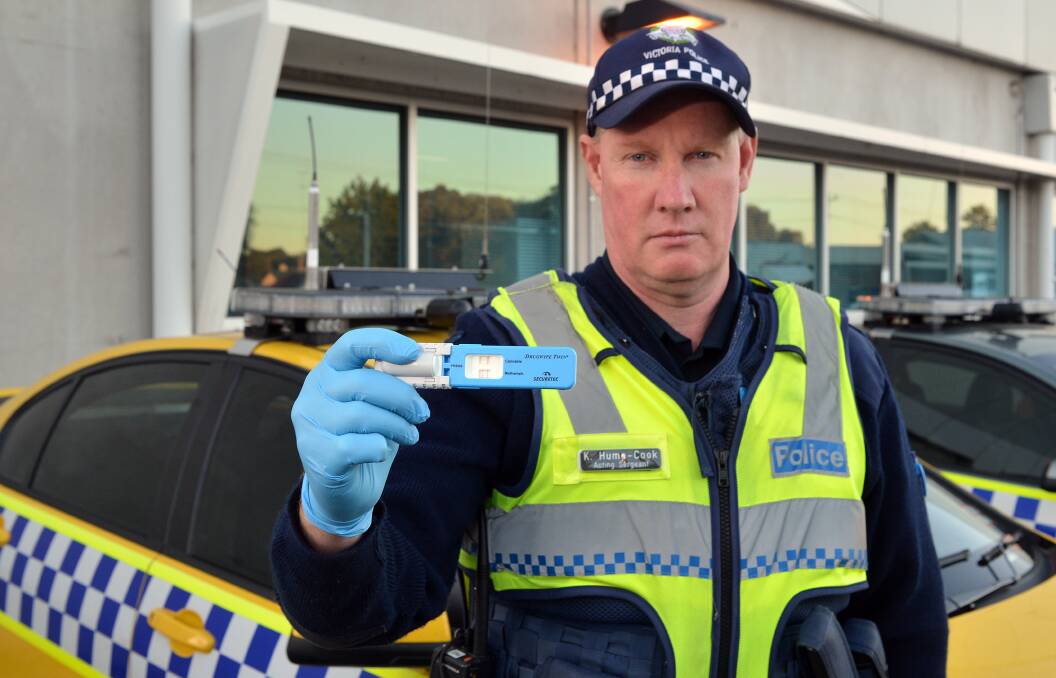 FOCUS: Acting Sergeant Kevyn Hume-Cook holds a positive test conducted during a blitz on drug drivers. Picture: LIZ FLEMING