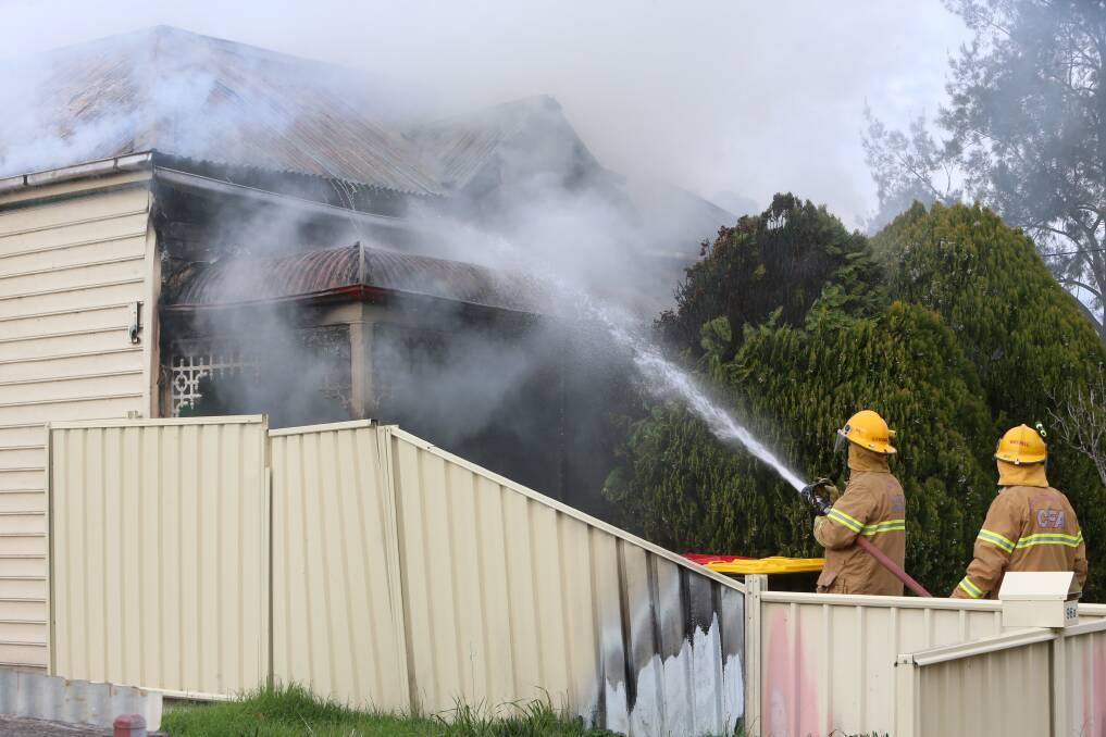 DEVASTATING: Firefighters work to contain the blaze at the Trenfields' Ascot home. Picture: PETER WEAVING