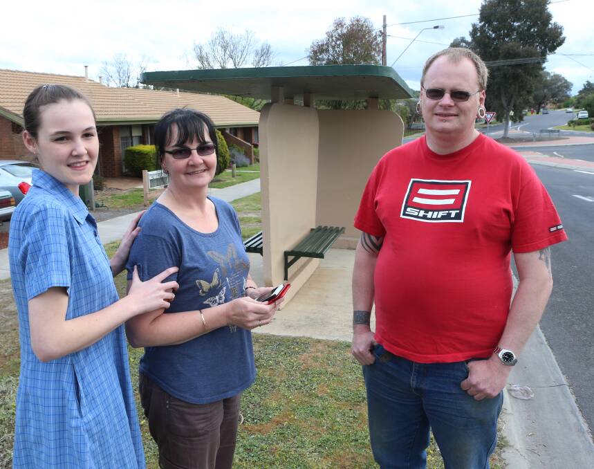 CLOSE CALL: Tahnicia,15, Alyssa Creely and Paul O'Neill at the bus stop where they found the missing man. Picture: PETER WEAVING