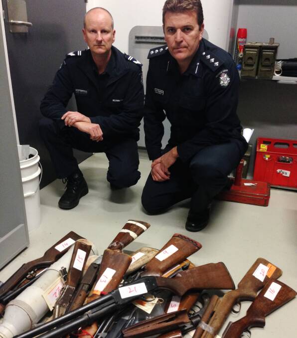 ILLEGAL: Firearms officer Mark Wilkinson and Acting Inspector Troy Hargadon with a pile of confiscated guns which will soon be destroyed. Picture: ANDI YU