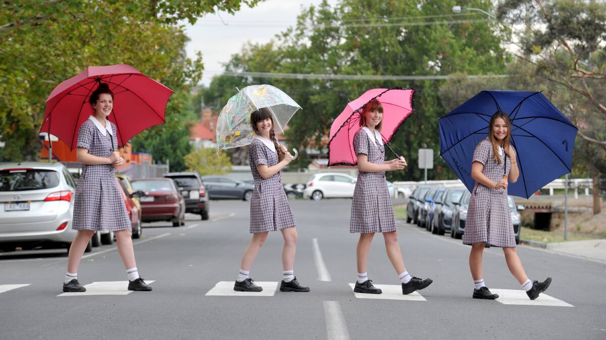 FUN: Girton Grammar students Iona Moller, Georgia Jenkins-Smales, Sarah Rowe and Emajane Fisher welcomed yesterday's rain. Picture: JODIE DONNELLAN