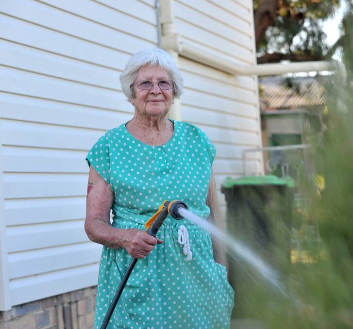 KEEPING COOL: Sylvia Bolitho waters her garden to prepare for the heat. Picture: JODIE DONNELLAN