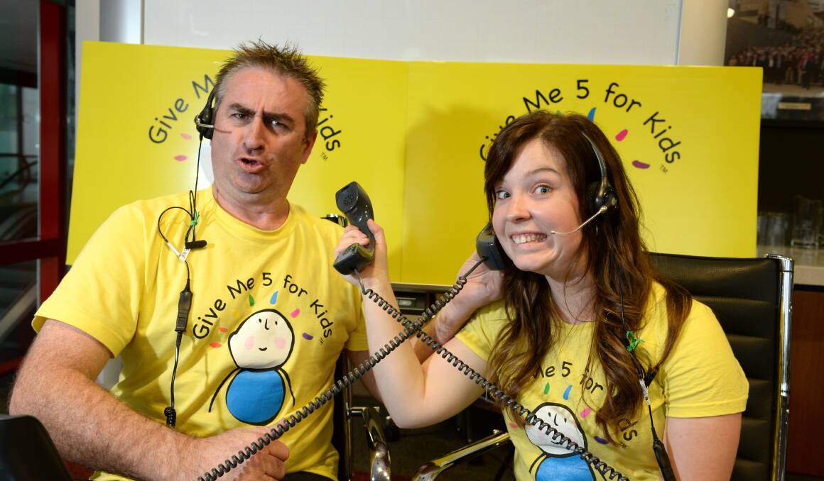 AT WORK: Bryan Coghlan and Jess Elsley taking calls at Friday's telethon. Pictures: JIM ALDERSEY