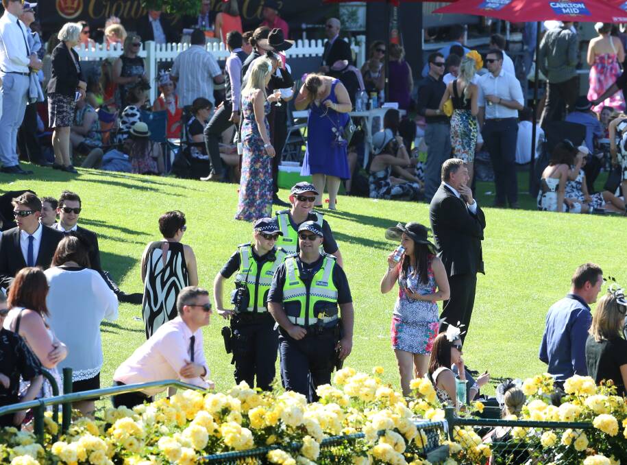 ON DUTY: Police keep an eye on the crowds yesterday. Picture: PETER WEAVING