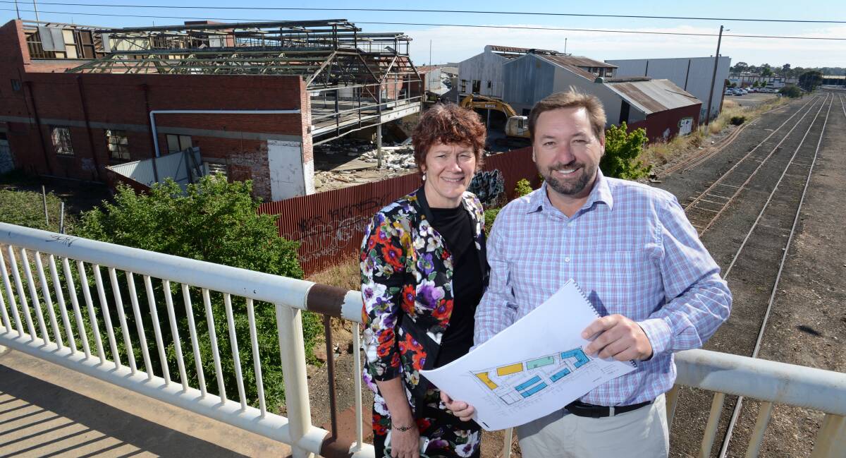 FUTURE: Prue Mansfield and Phil DeAraugo with plans for the old Gillies site. Picture: JIM ALDERSEY