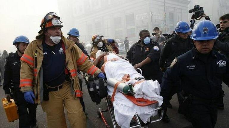 A victim is evacuated by emergency personal near an apparent building explosion and collapse in the Harlem section of New York City. Photo: Reuters