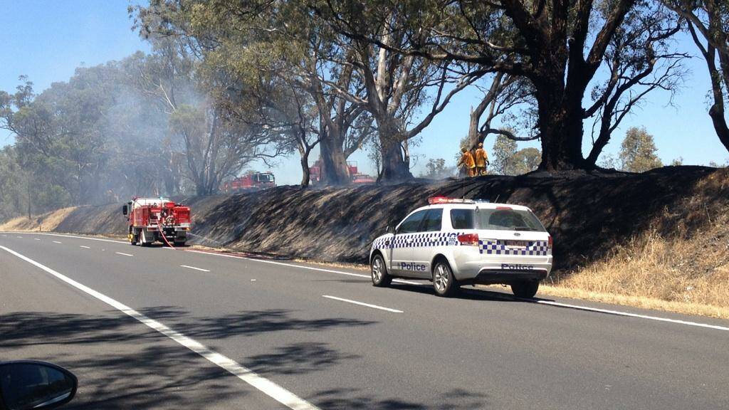 CFA members and police attend a grassfire at Ravenswood south on Wednesday. Picture: JODIE DONNELLAN