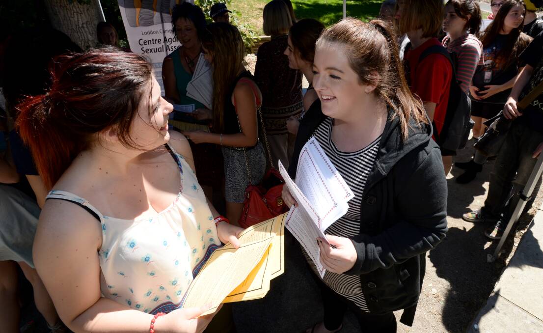 Morgan McQualter and Mikaela Monigatti hand out information about safe sex. 