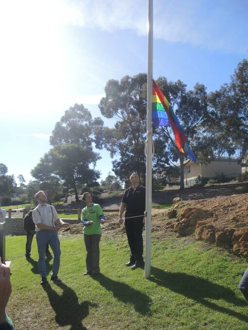 CELEBRATE: Scotty Dealy and Jan Taylor raise the flag. Picture: ANDI YU