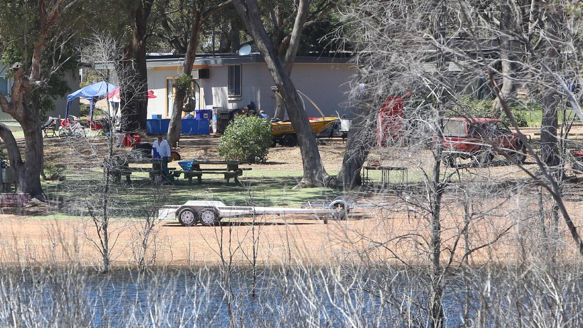 The the boat (yellow) that caught fire on Lake Eppalock on Saturday morning.