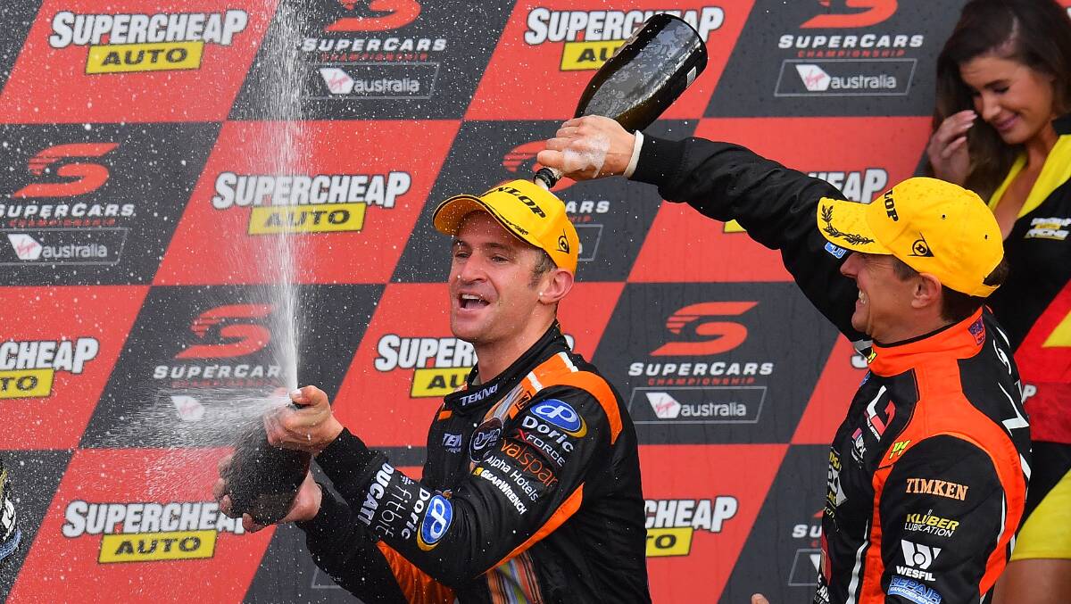 Living vroom: Will Davison and Cameron McConville celebrate on the podium after the Bathurst 1000 at Mount Panorama. Photo: Getty Images