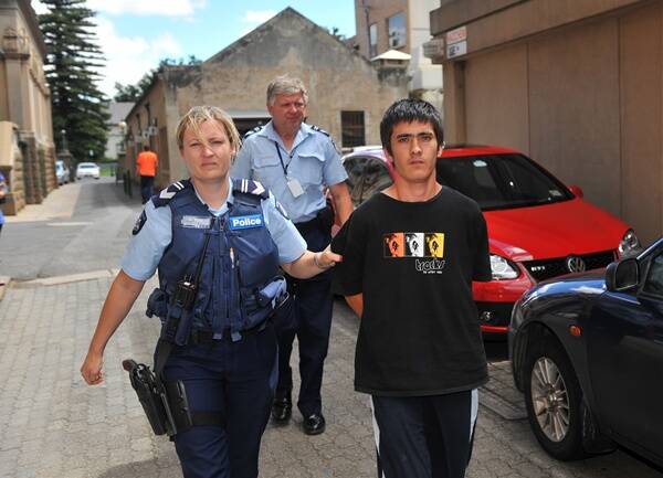 Mohammad Zaoli, 21, is led into Bendigo Magistrates Court yesterday before being granted bail on gang rape charges.