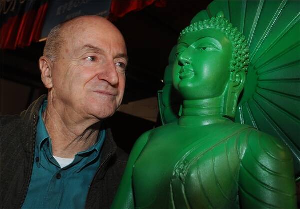 WONDER: Ian Green, who will travel with the jade Buddha, poses next to an early facsimile of the real statue.